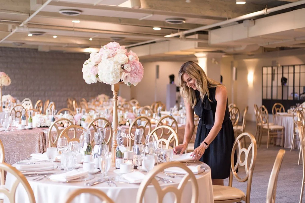 A wedding planning perfecting table settings