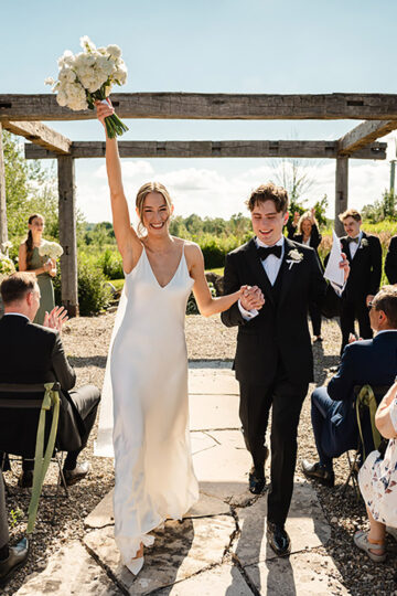 A couple celebrating as they walk down the aisle