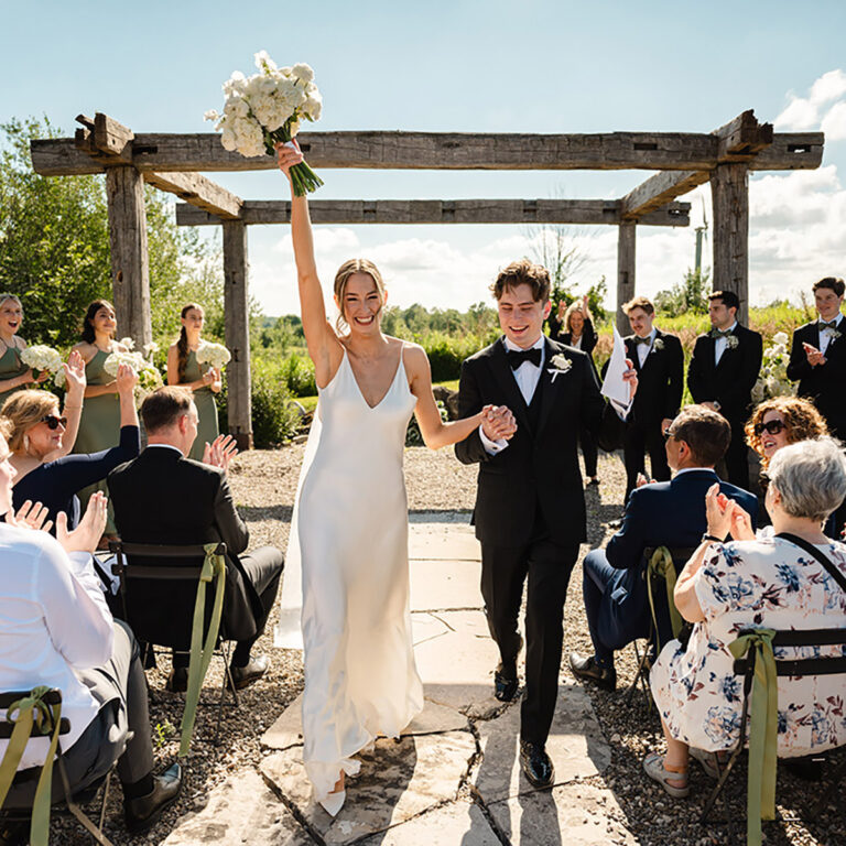 A couple celebrating as they walk down the aisle