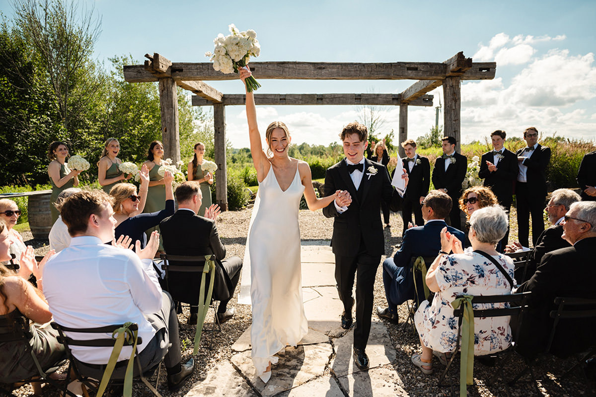 A couple celebrating as they walk down the aisle