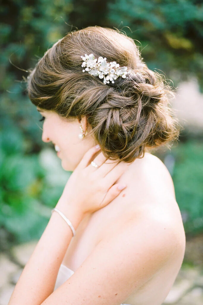 A close up of bridal hair with a broach