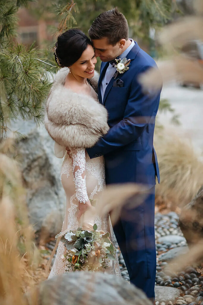 A couple while they snuggle on their wedding day