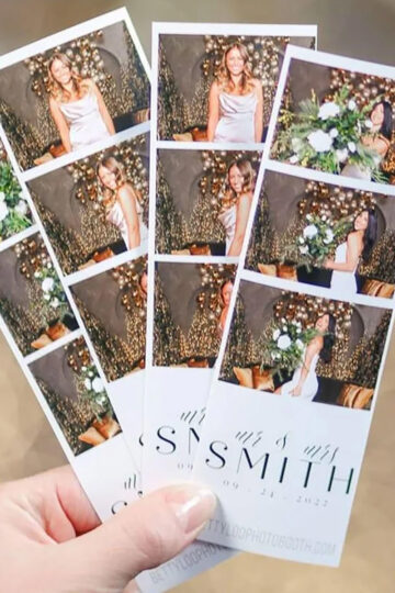 A hand holding 4 printed photo booth photo strips