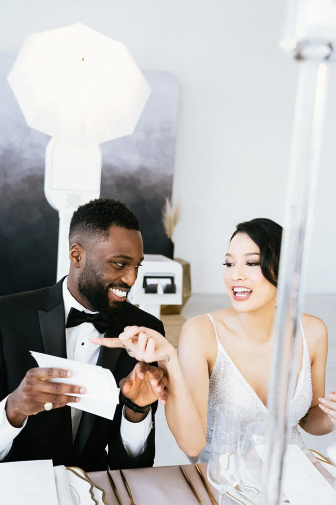 A couple looking at their images just taken in a photo booth