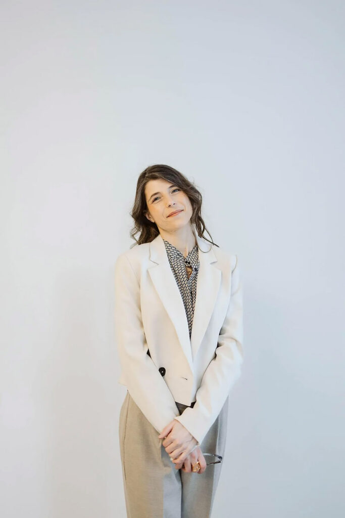 A girl standing with her hands crossed