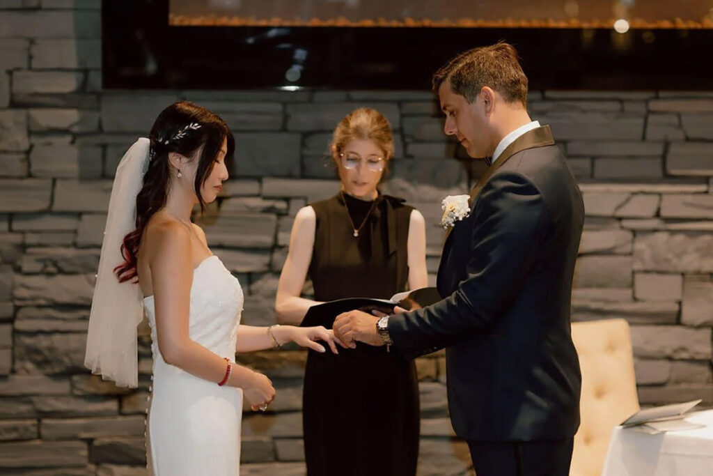 A couple exchanging their rings during their ceremony
