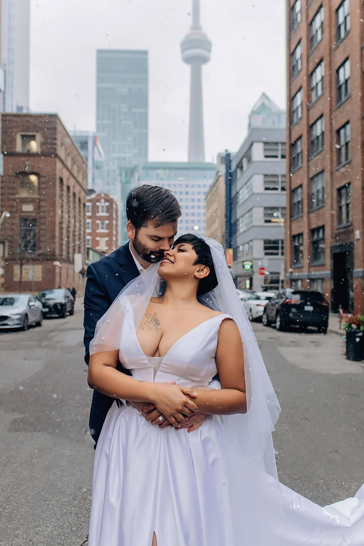 A couple in the middle of the street cuddling in toronto