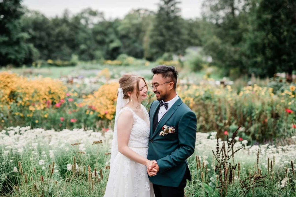 A couple embracing with a soft field behind them