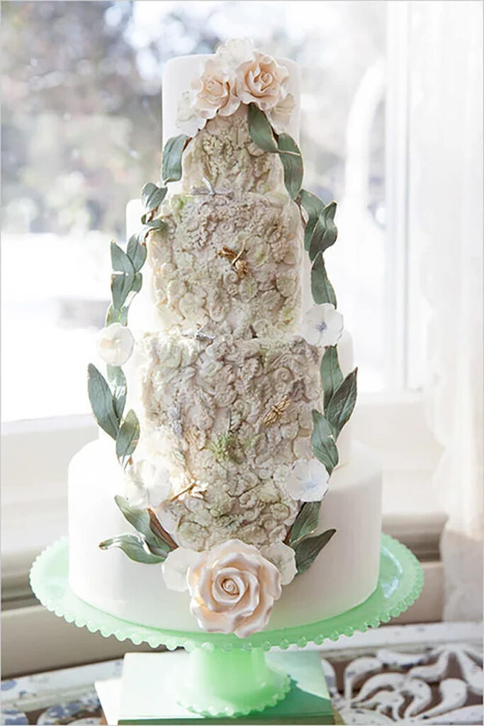 A 4 tier cake with flowers on it