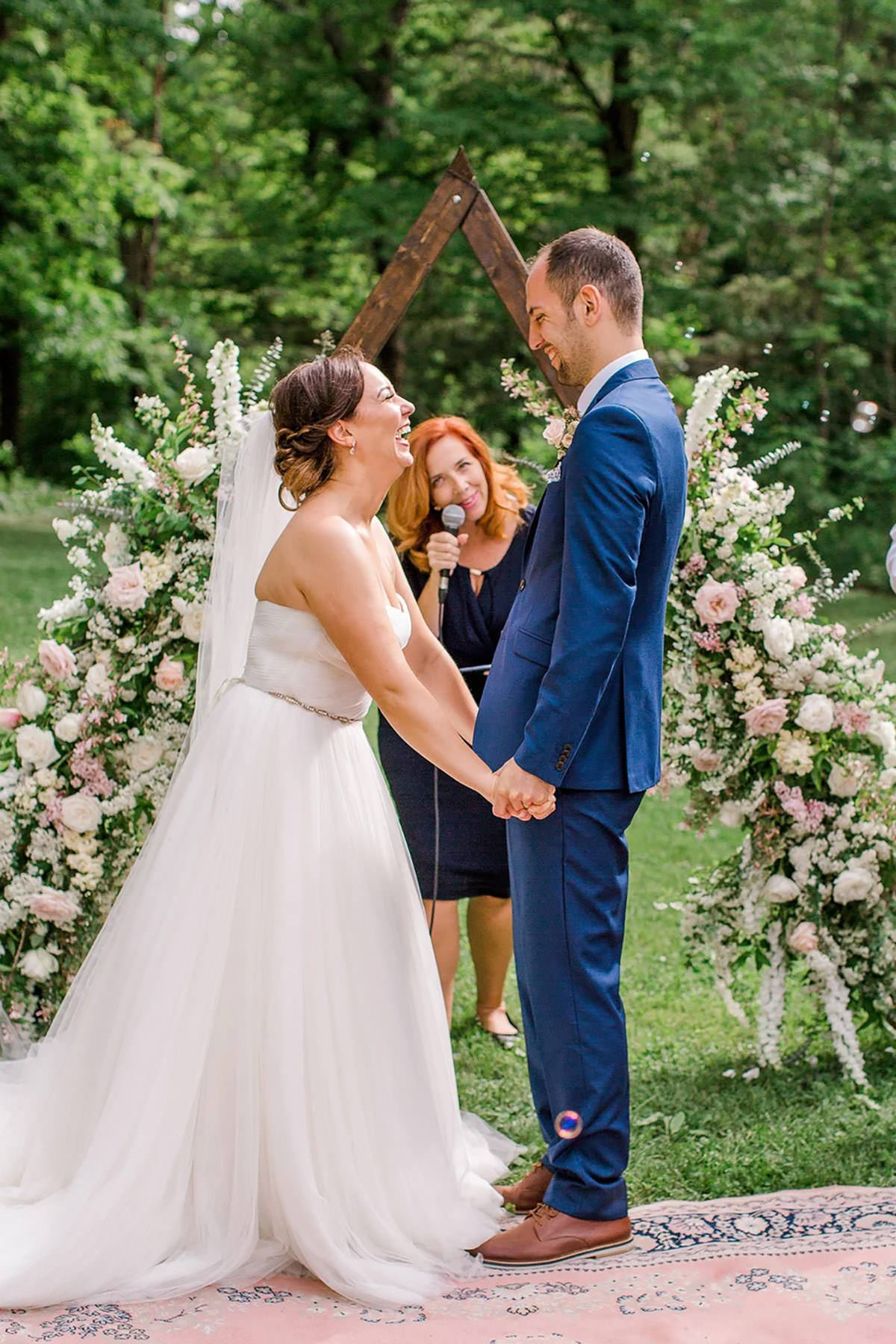 A couple saying their vows and laughing