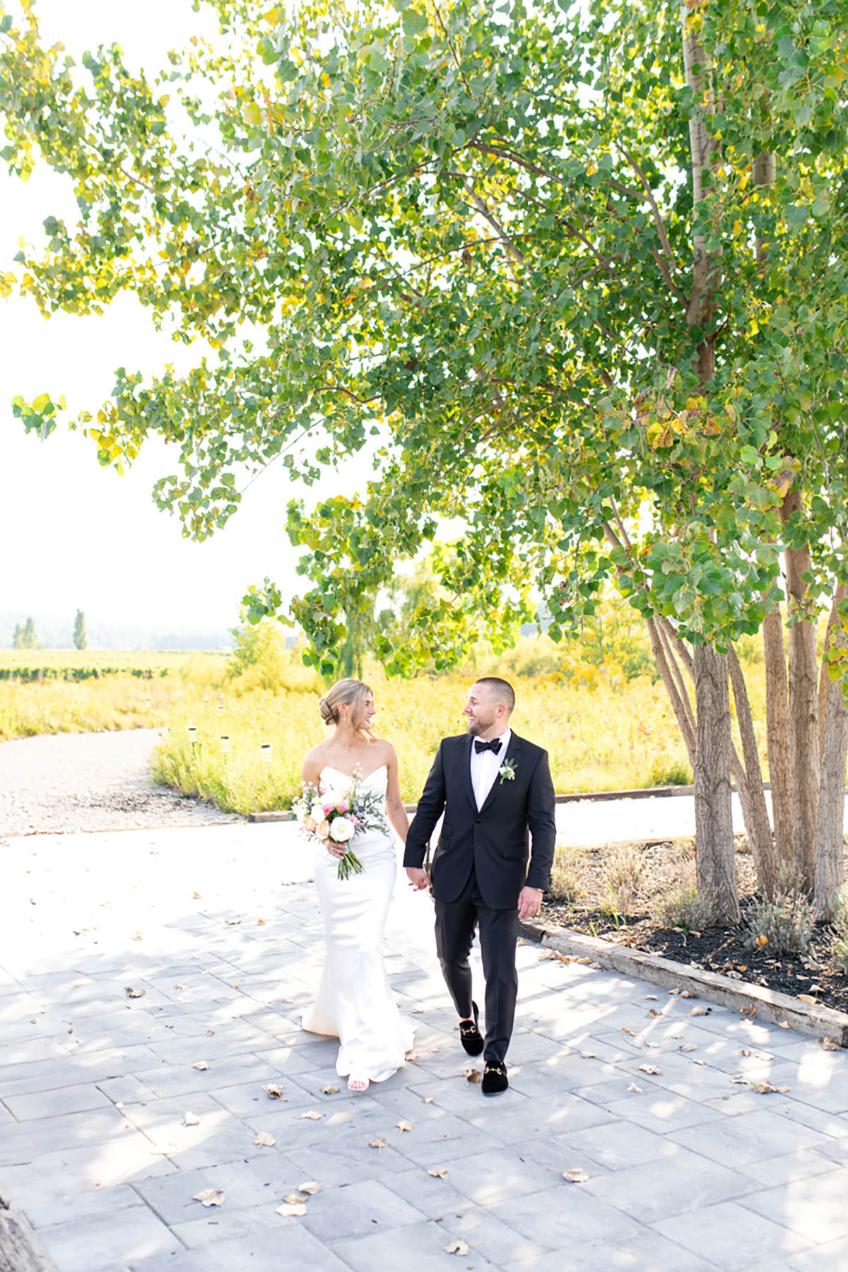 A groom and bride walking hand in hand