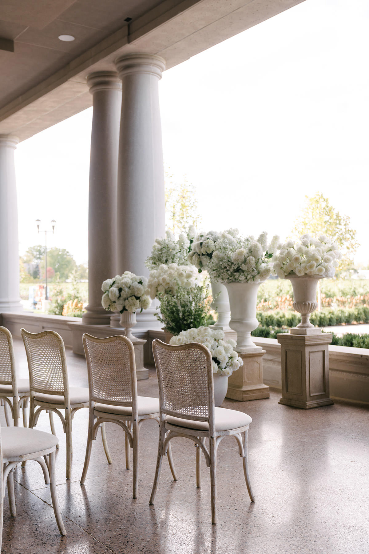 A ceremony setup on a large porch with lots of white flowers