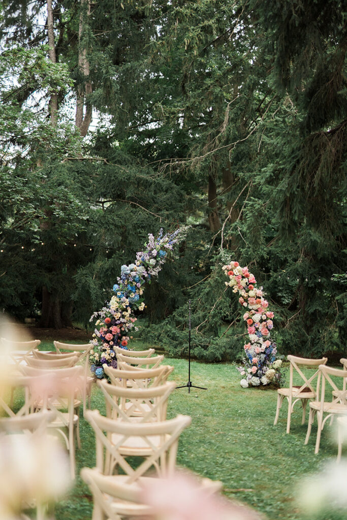 A ceremony arch of flowers in the distance.