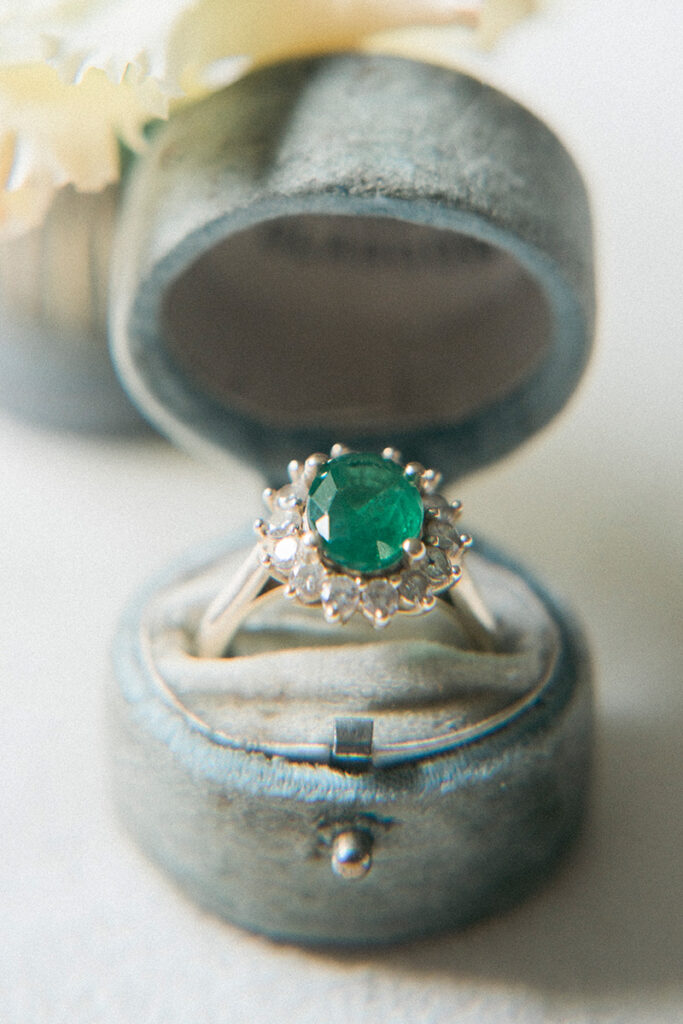 A beautiful green wedding ring in a pale blue case.
