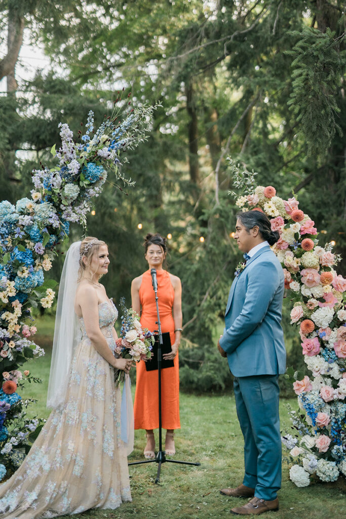 A couple getting married at an outdoor ceremony