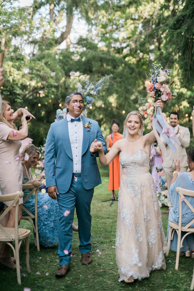 A couple cheering coming down the aisle.