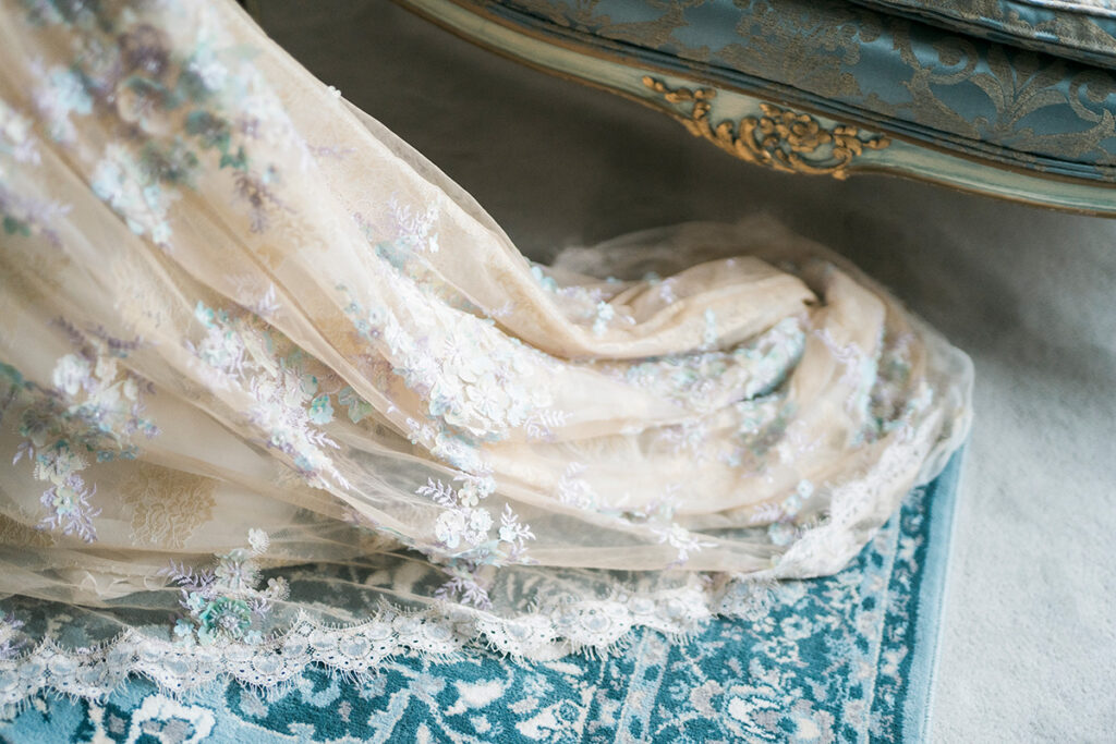 A close up detail of the train of a wedding gown.