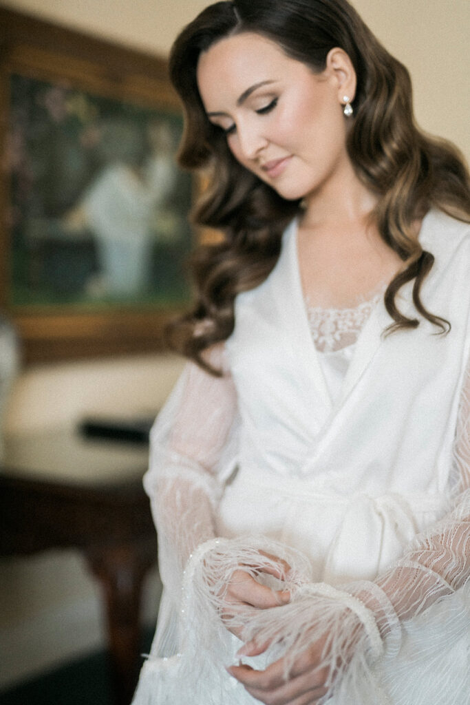 bride in a white robe getting ready