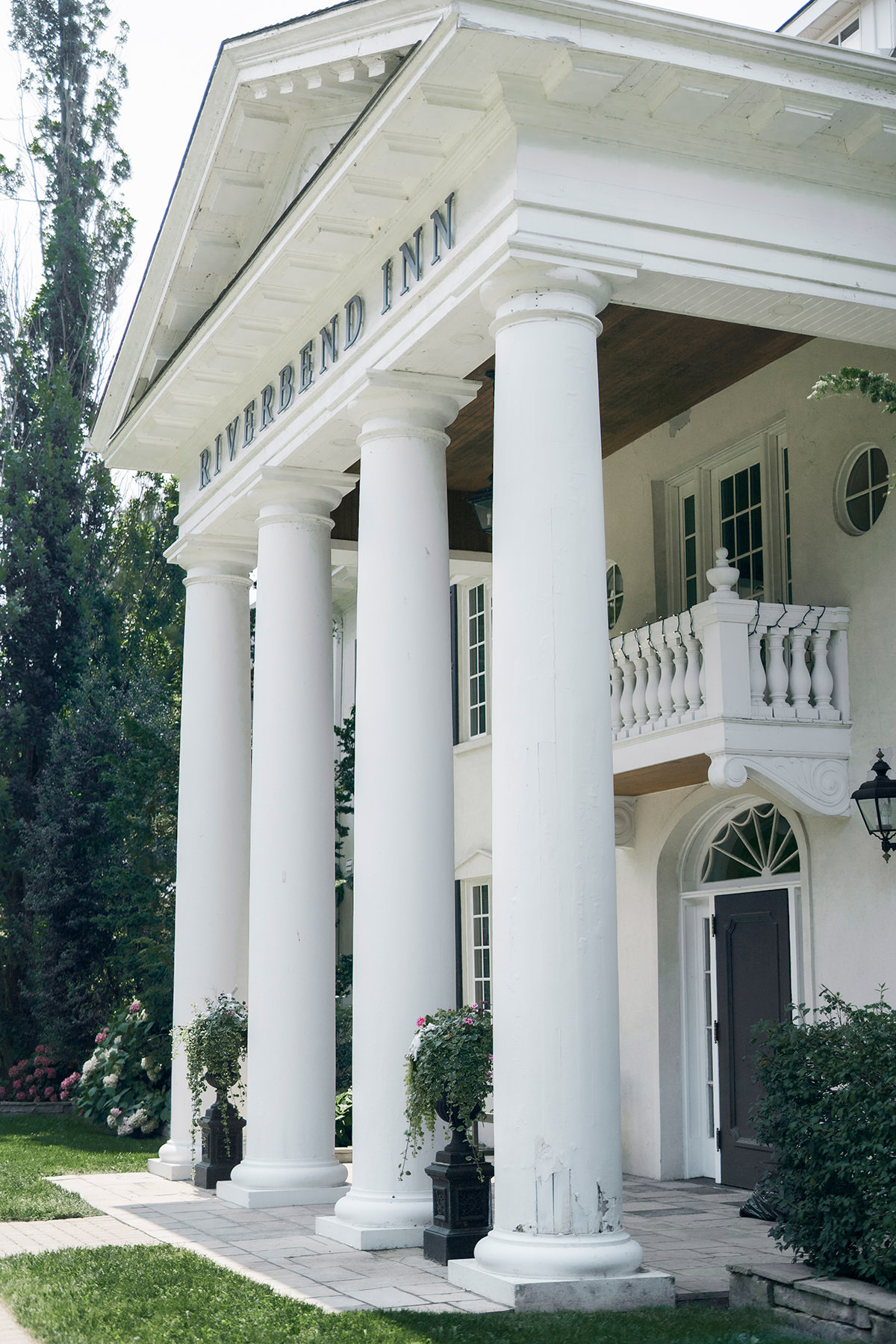 outside a grand inn and wedding venue with large columns