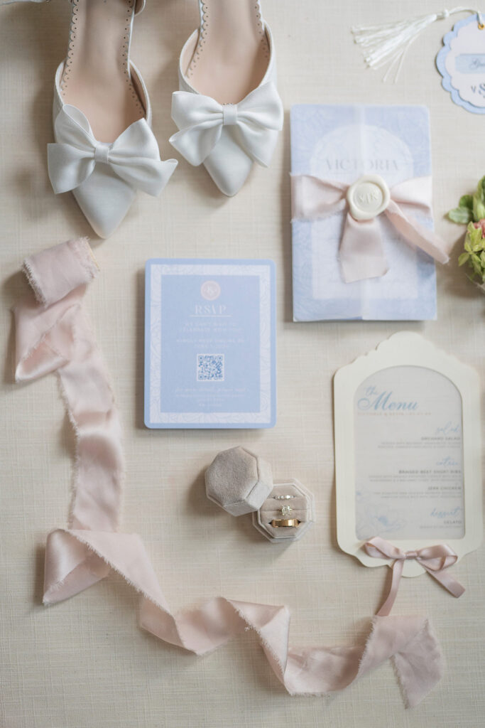 flatlay of wedding stationery and bridal shoes