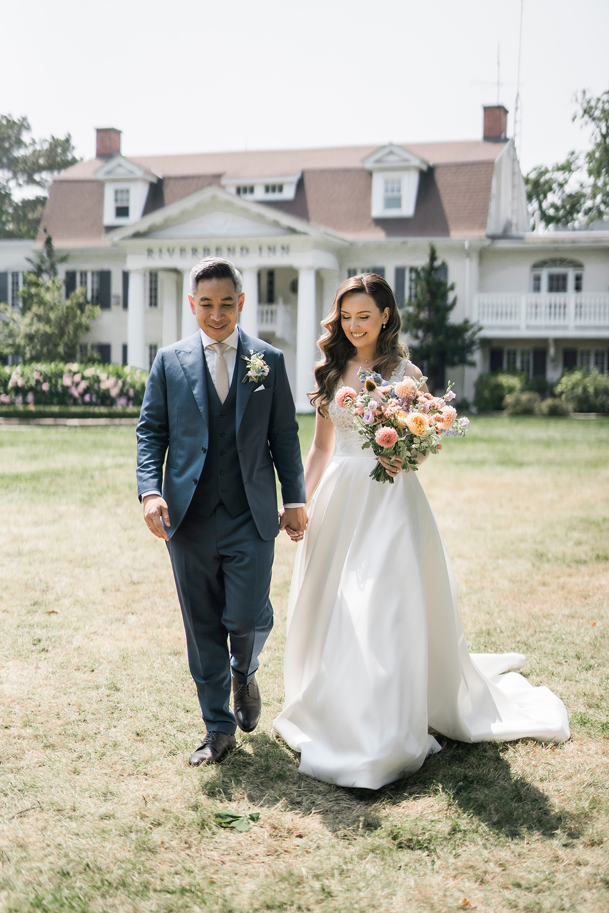 bride and groom walking hand in hand