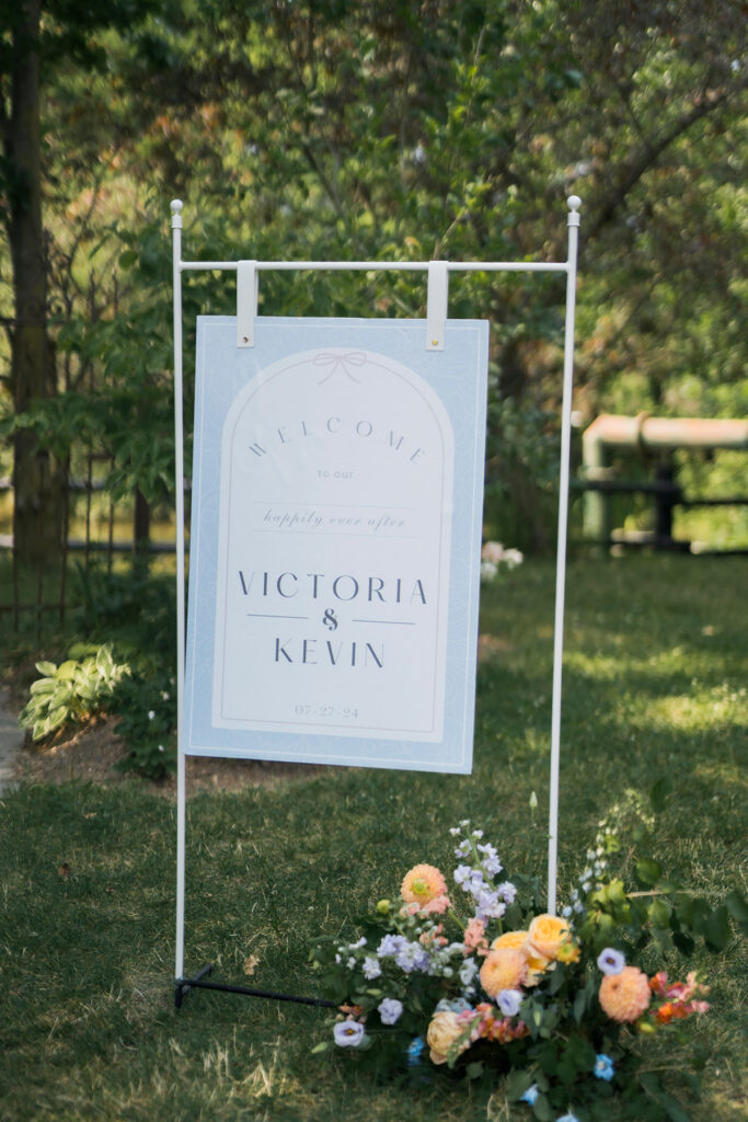 wedding welcome sign with floral arrangement