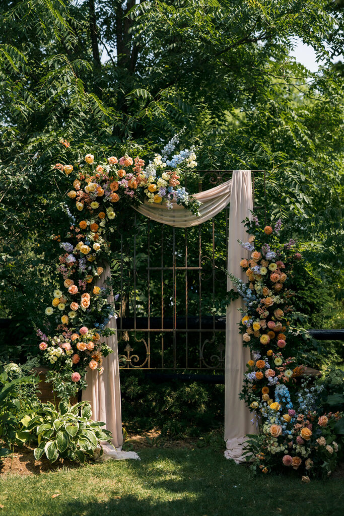 colourful wedding flowers for ceremony arch
