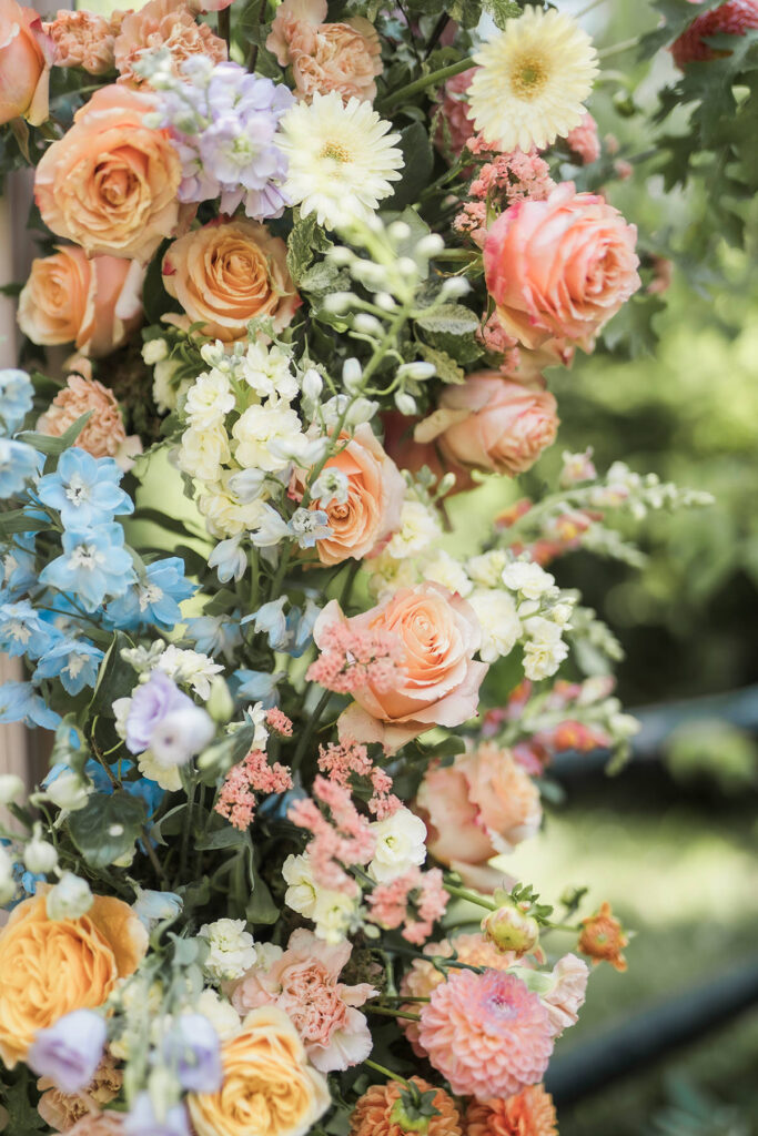 colourful wedding ceremony arch flowers