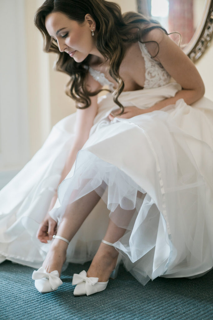 bride sitting and putting on her shoes