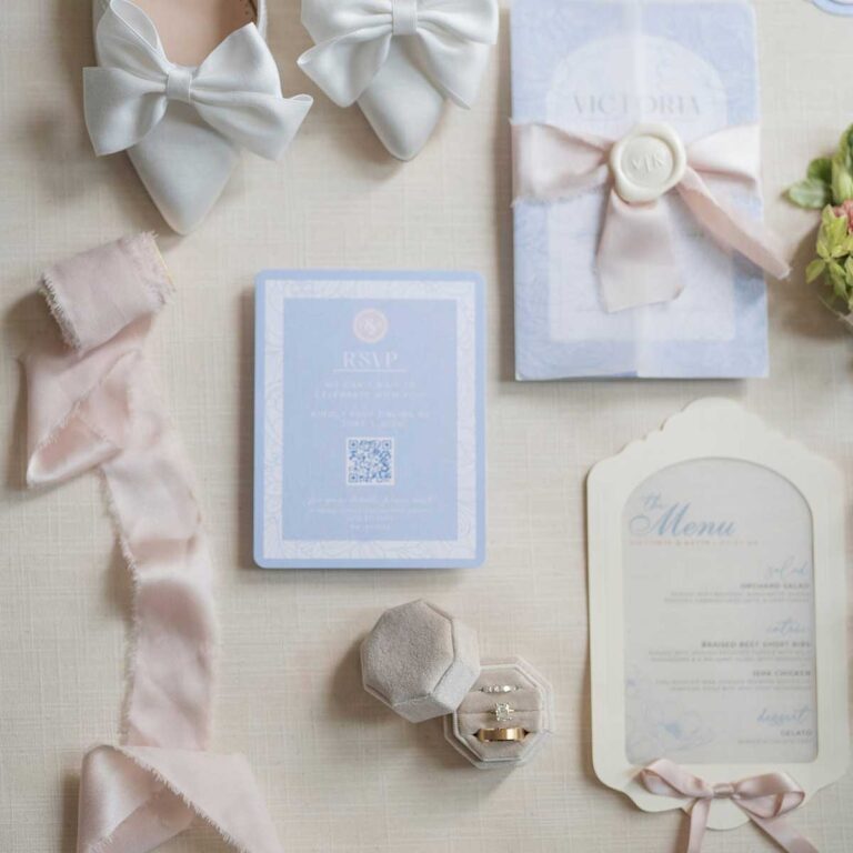 flatlay of wedding stationery and bridal shoes