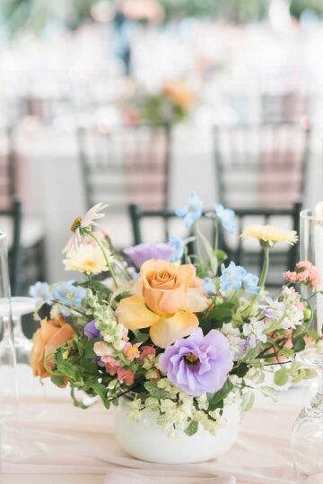 colourful floral centrepiece on wedding reception table