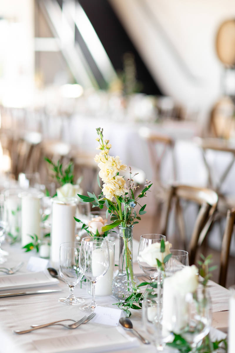 A tablescape showing candles and flowers.