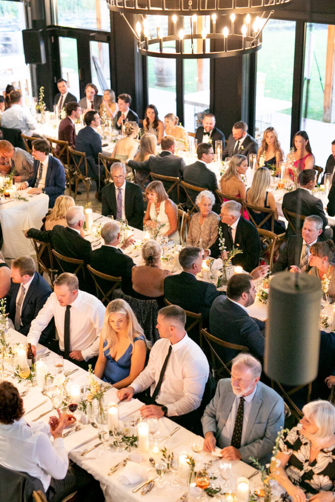 An overhead angle of a wedding reception and guests at their seats.