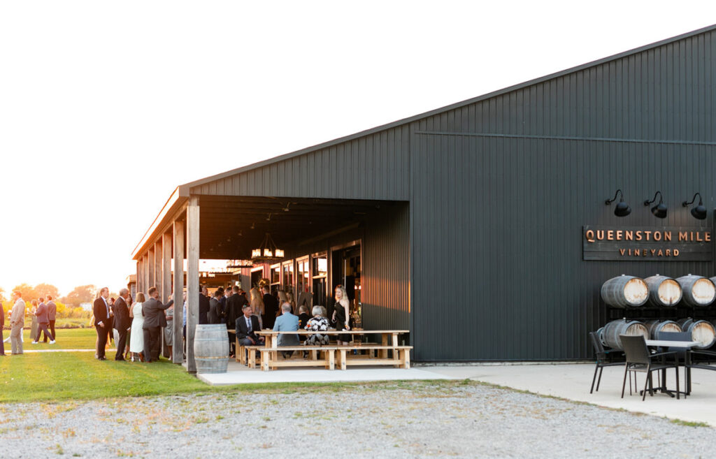 An exterior shot of Queenston Mile Vineyard with guests outside.