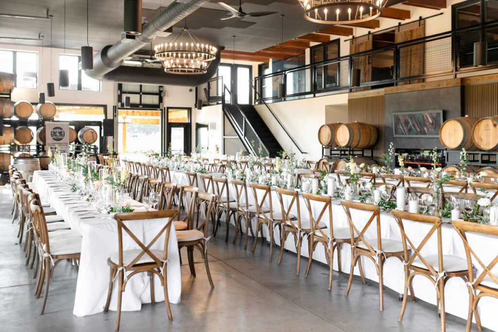 A winery wedding reception set up with long tables.
