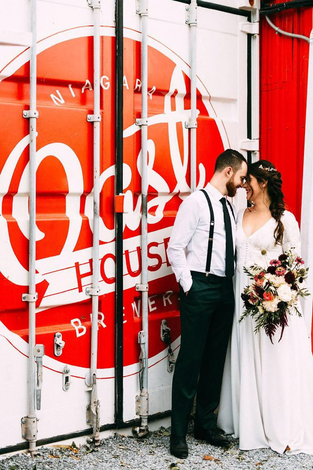 A couple standing in front of Oast House Brewers