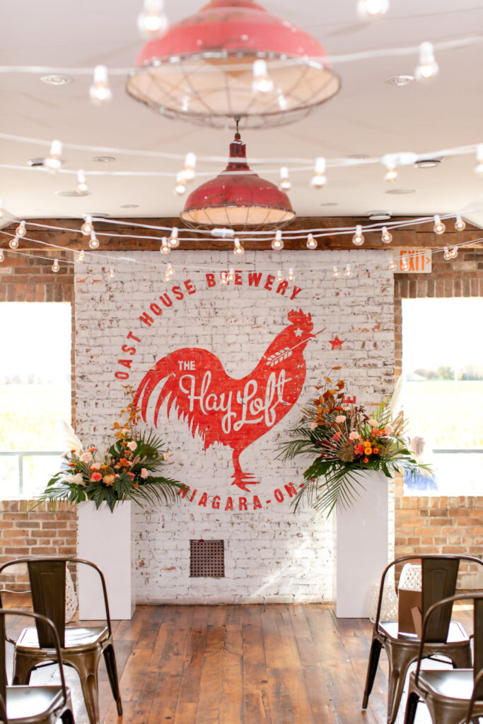 Ceremony set up at Oast House with florals and string lights