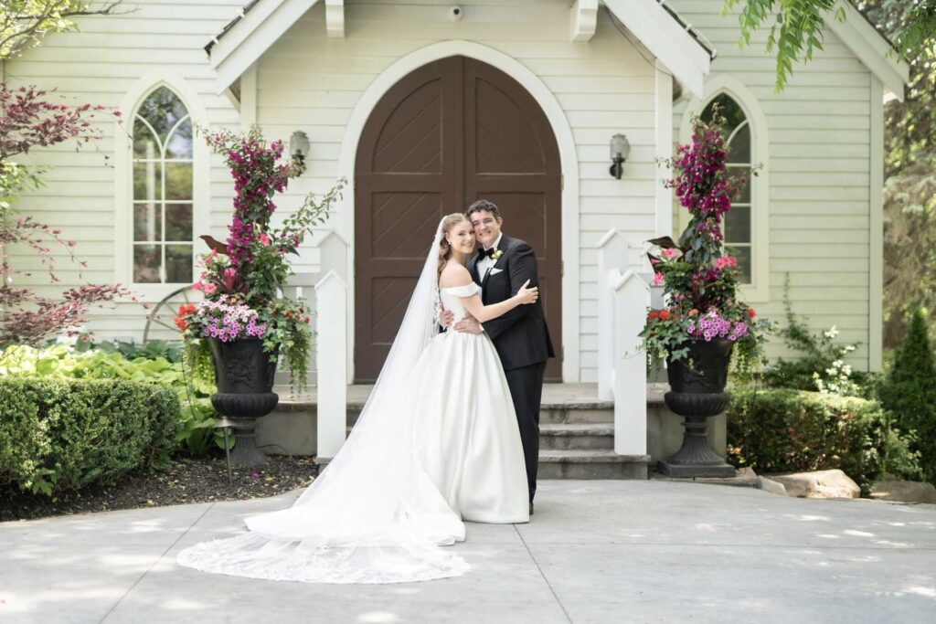 bride and groom outside chapel doors at the doctor's house