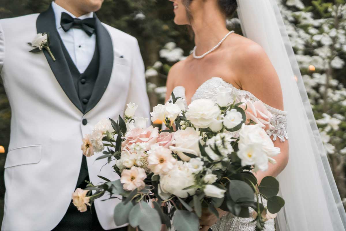 crop of bride and groom with bride holding bouquet