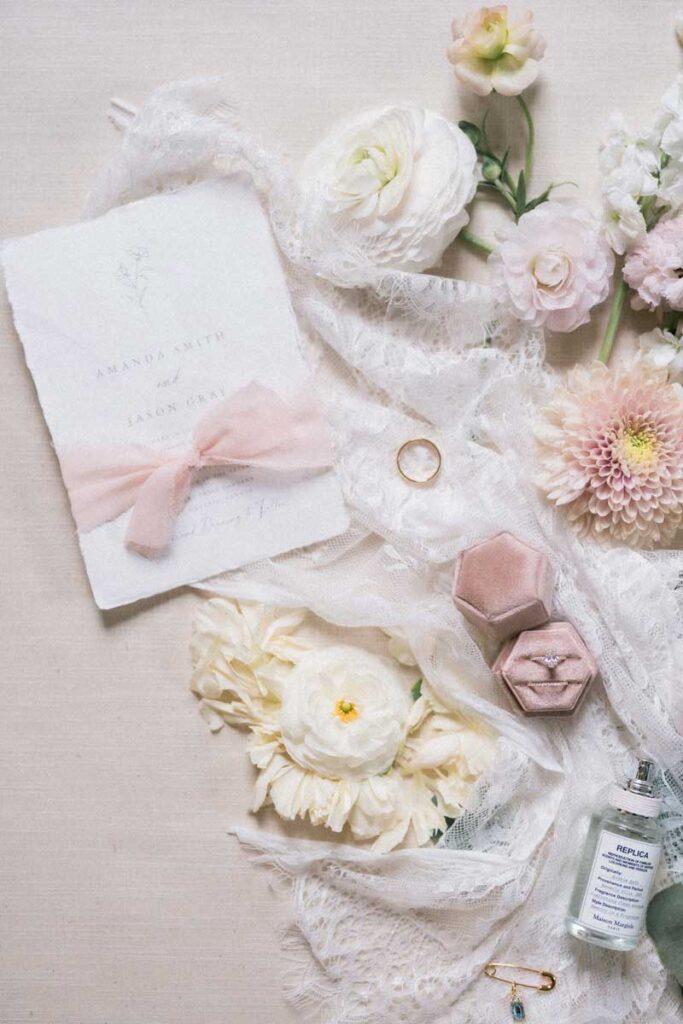 flatlay of bridal details and wedding invitation