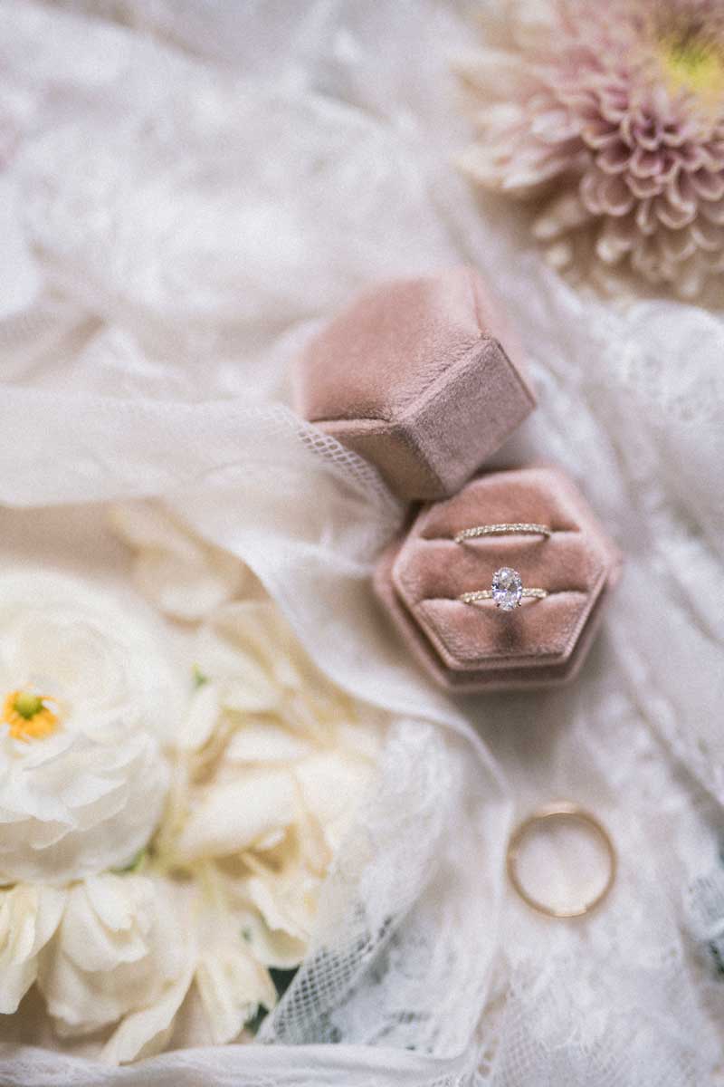 pink velvet ring box with floral flatlay