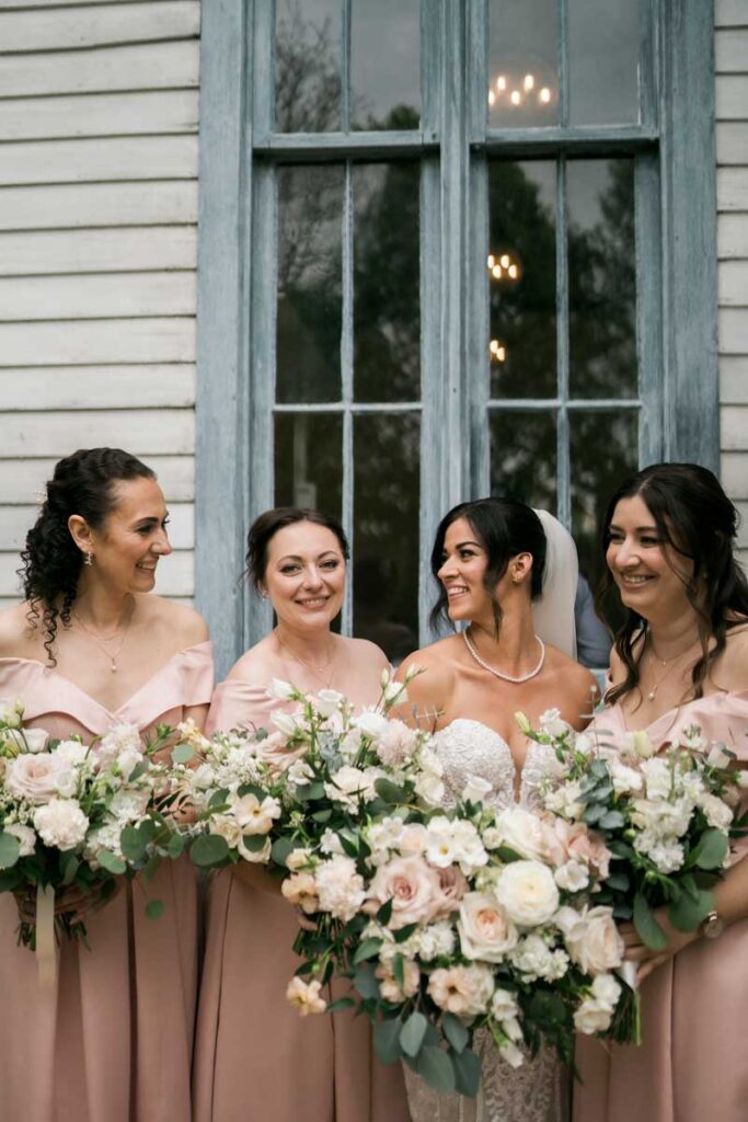 bride with her bridesmaids wearing pink gowns