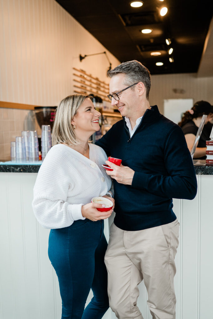 couple in coffee shop holding mugs