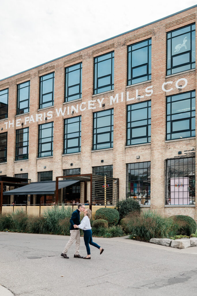 couple standing in front of industrial building coffee shop