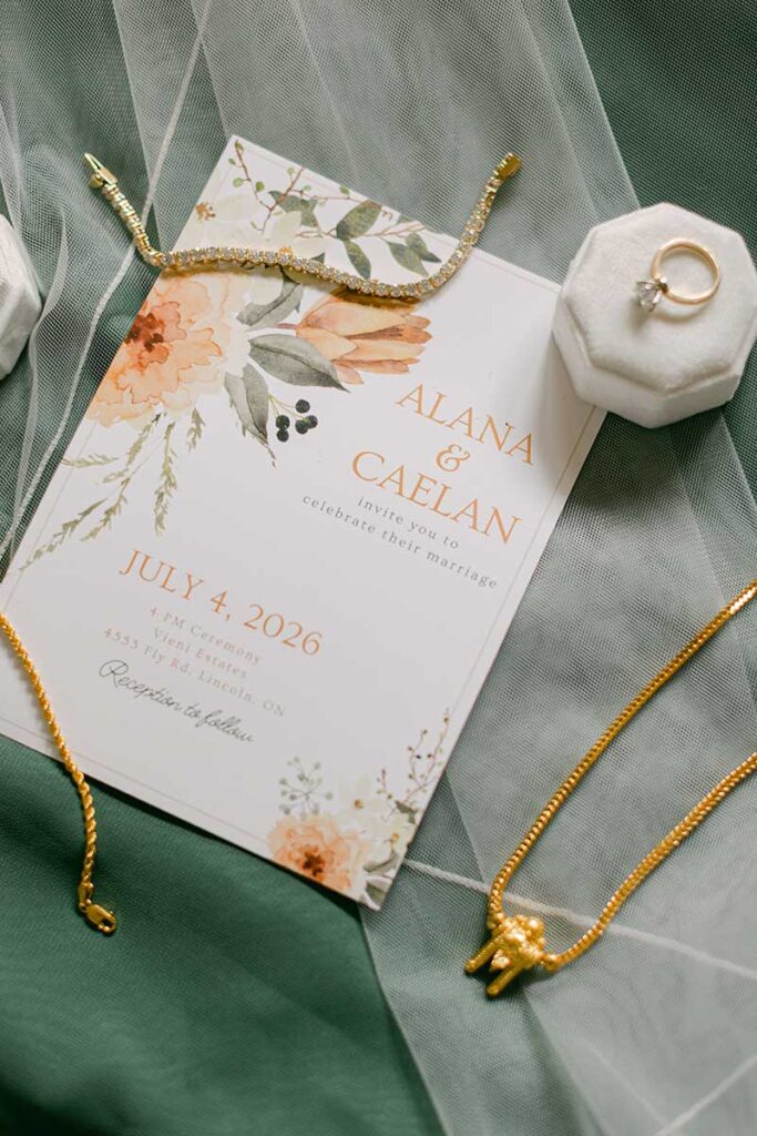 wedding invitation flatlay with bridal jewellery