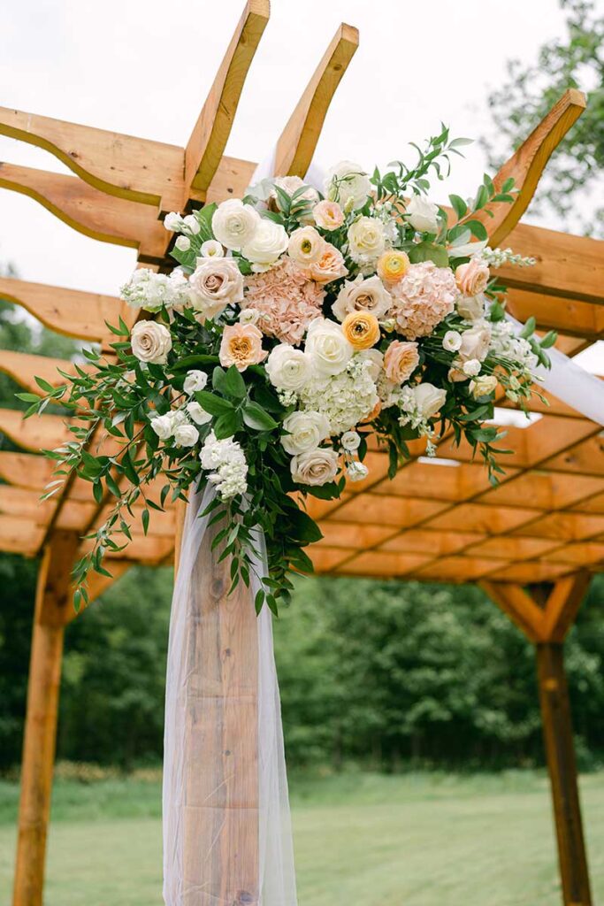 floral arrangement on wooden arbour