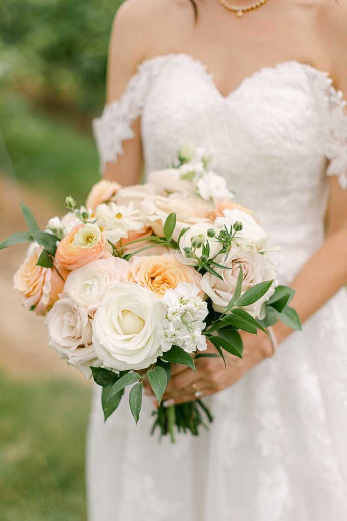 close up of white and peach bridal bouquet