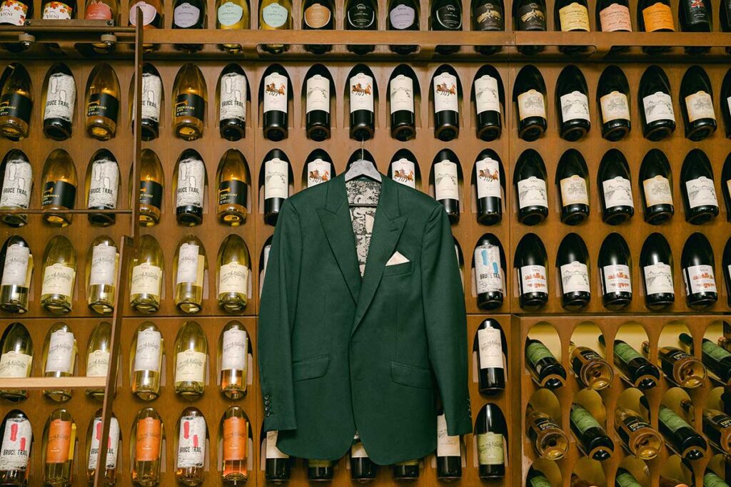 groom suit jacket hanging up in wine cellar